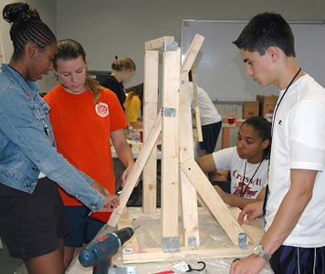 Students at a STEM seminar assemble a catapult