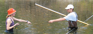 Two students gathering streamflow data in the Cannon River