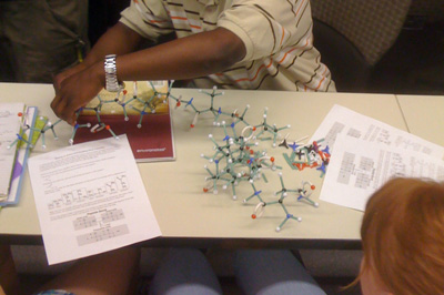 Photo of students workin with models