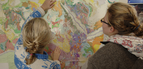 photo of students in front of a geologic map