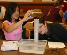 Students measuring water displacement